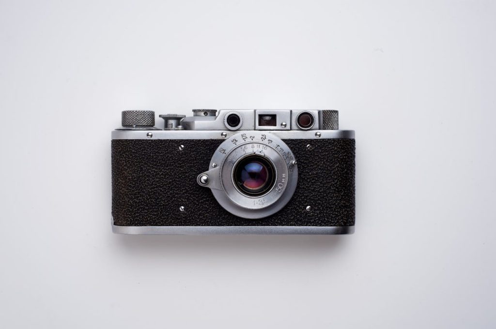 Classic vintage film camera captured in a minimalist flat lay style on a white background.